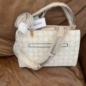Guess women handbag in cream base color.